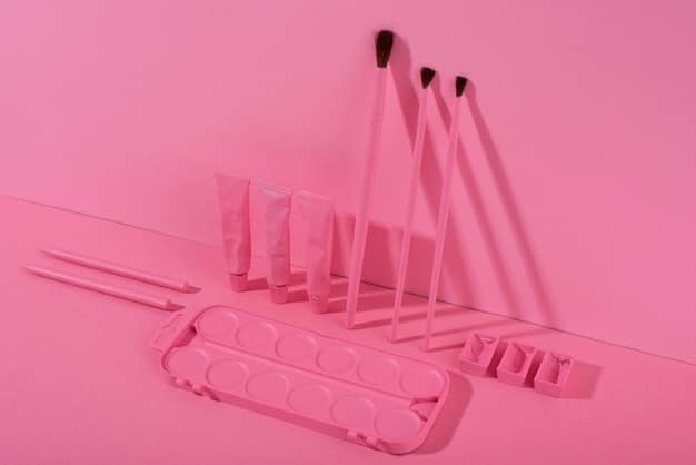 A variety of makeup brushes laid out on a light pink surface, ranging in size and shape, used for applying different types of makeup.