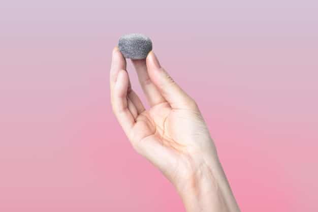 A hand holding a makeup sponge, gently blending a color correcting cream into the skin. The focus is on the blending motion and the seamless integration of the product.