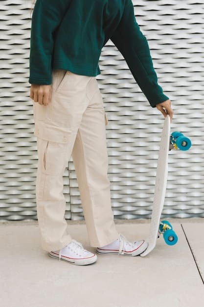 A person wearing stylishly fitted cargo pants with a tucked-in graphic tee and chunky sneakers, showcasing a modern and edgy unisex look.  The image should emphasize the versatility and coolness of cargo pants.