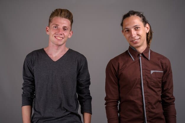 Two side-by-side images: On the left, a person wearing a fitted unisex button-down shirt tucked into high-waisted trousers; on the right, the same person wearing the same shirt untucked with the sleeves rolled up, paired with jeans. The images demonstrate how the same shirt can create different looks based on styling.