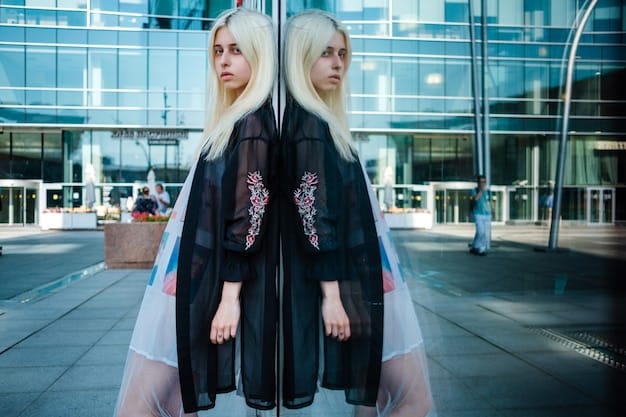 Non-binary model in a studio, wearing an oversized blazer layered over a sheer mesh top and a graphic tee. The blazer features bold geometric patterns, and the overall look is completed with chunky platform boots and statement jewelry. The image showcases the layering of textures and silhouettes for a striking non-binary fashion statement.