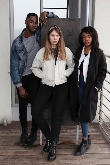 A diverse group of individuals showcasing different androgynous outfits. One person wears a well-tailored suit with sneakers, another wears a flowing skirt with a blazer, and a third wears a jumpsuit with combat boots. The outfits highlight the versatility and inclusivity of androgynous fashion.