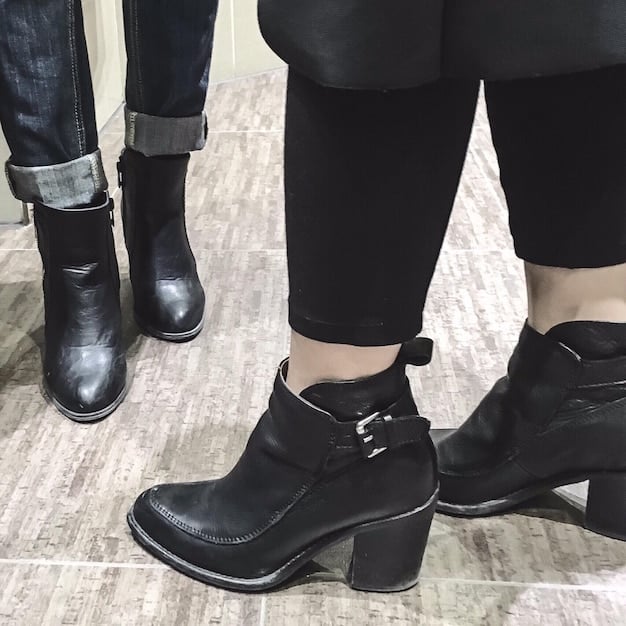 A collection of androgynous footwear suitable for fall, including leather boots, tailored loafers, and minimalist sneakers in neutral colors like black, brown, and white. The image highlights the versatility and timelessness of these shoe styles.