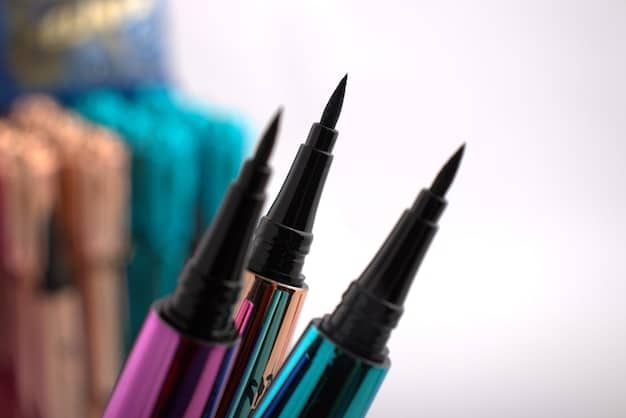 A selection of different types of eyeliners, including pencil, gel, and liquid, displayed on a clean surface. The focus is on the variety of application tools available for men's eyeliner.
