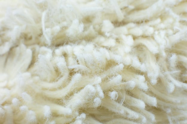 A close-up shot of different fabric textures used for layering, including merino wool, fleece, cotton, and a waterproof synthetic material, showcasing the distinct weaves and properties of each fabric.