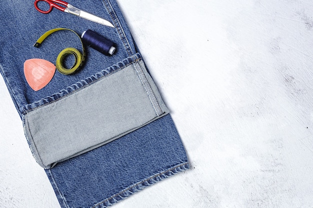 A detailed flat lay of various unisex fabrics and their corresponding cuff examples: crisp denim with a tight roll, soft linen with a loose scrunch, and cotton twill with a classic fold, showcasing textural differences and optimal cuff styles.
