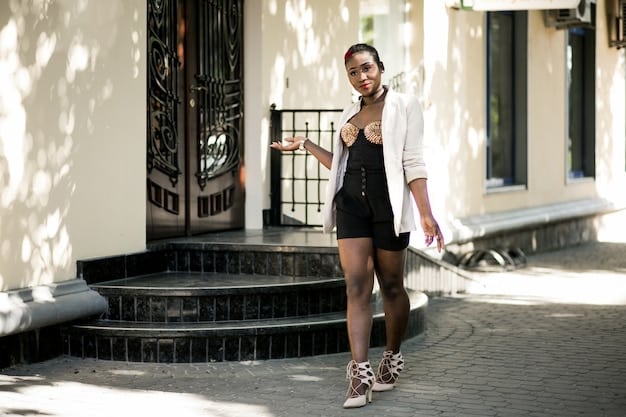 A person wearing an oversized blazer with rolled-up sleeves, paired with a skirt and chunky sneakers. They are walking down a city street, showcasing a deconstructed classic style.