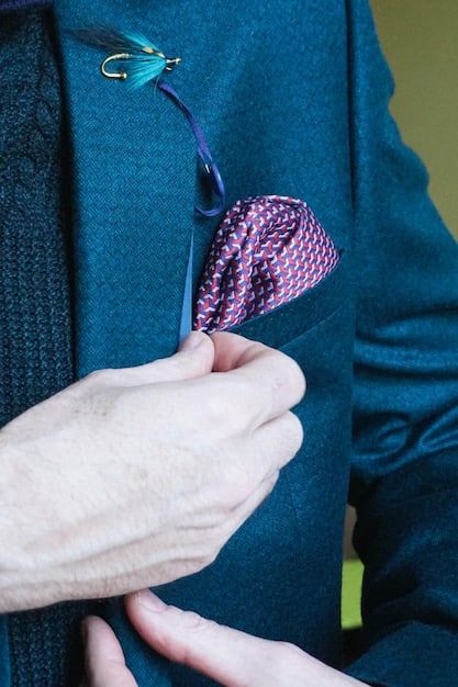 A close-up shot of a non-binary person wearing a unique lapel pin on their blazer, showcasing a creative and personalized touch.