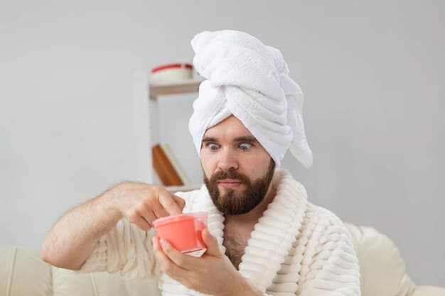 A man gently exfoliating his lips with a homemade sugar scrub, his expression focused and careful. The setting is a clean, modern bathroom with soft lighting.