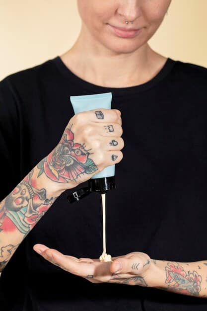 A man gently patting a freshly covered tattoo area with a clean hand, demonstrating care and maintenance, with a soft, blurred background suggesting a daily routine.