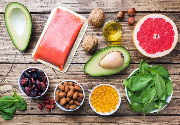 A selection of healthy foods rich in omega-3s and antioxidants, such as berries, nuts, salmon, and leafy greens, illustrating a diet beneficial for skin health.