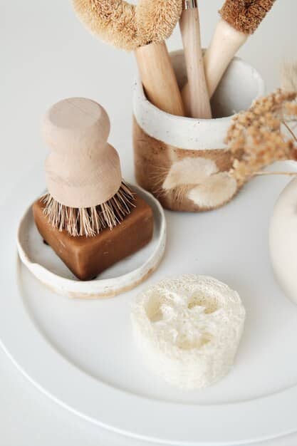 A close-up of a diverse range of exfoliation tools and products (chemical exfoliants, gentle physical scrubs, exfoliating mitts) neatly arranged, suggesting a comprehensive approach to skin preparation.
