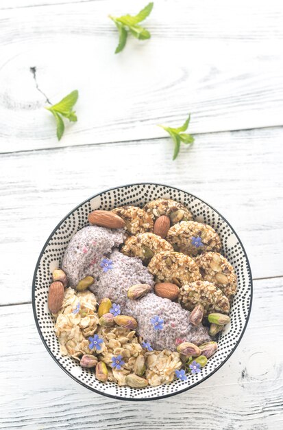 A visually appealing bowl filled with a colorful mix of nuts and seeds (almonds, walnuts, pumpkin seeds, sunflower seeds), emphasizing their natural, wholesome qualities as healthy skin foods.
