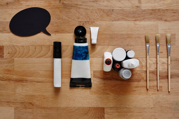 A sleek, minimalist display of gender-neutral makeup products (e.g., tinted moisturizers, brow gels, concealers) with clear, elegant packaging, appealing to a diverse demographic. The products are arranged on a light wood or concrete surface.
