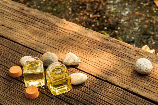 A close-up shot of various natural carrier oils and essential oils, clearly labeled, arranged neatly on a wooden surface, highlighting quality ingredients.