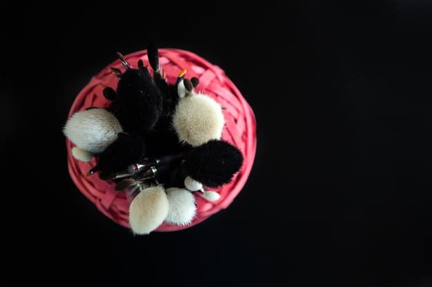 A close-up, high-angle shot of a luxurious, neatly arranged set of men's makeup brushes with dark, elegant handles and soft, perfectly shaped bristles, reflecting subtle lighting. The brushes are pristine, hinting at their premium quality.