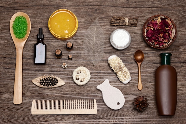 A detailed flat lay of various natural ingredients associated with hair growth, such as saw palmetto berries, biotin capsules, and small bottles of argan and rosemary oil, arranged around a bottle of organic shampoo. The composition is clean and highlights the natural essence.