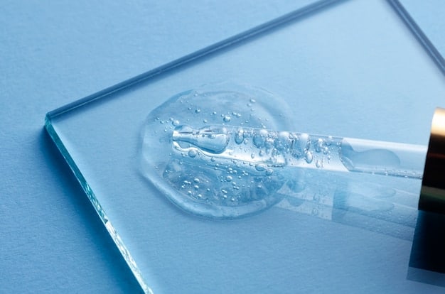 A close-up shot of a test tube with a clear liquid, symbolizing scientific research, and tiny water droplets on a surface, representing hydration.