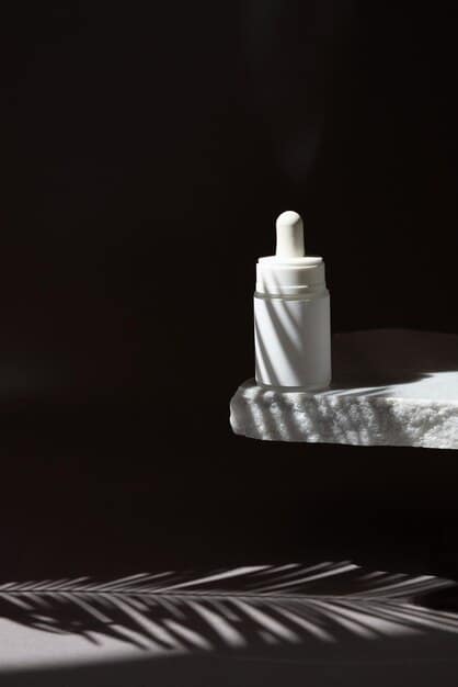 A minimalist skincare product bottle with a dispenser, showcasing a sleek design, placed on a smooth, reflective surface with soft lighting.