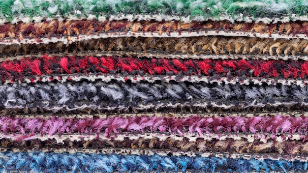 A close-up shot of various wool fabrics, including tweed, worsted wool, and flannel. The textures should be clearly visible, highlighting the differences in weave and weight. This is to illustrate the variety of wool options available for How to Choose the Right Suit Fabric for Every Season in 2025.