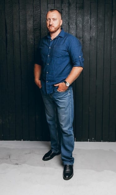 A man wearing dark wash jeans and a casual button-down shirt, standing in a relaxed pose. The focus is on the fit and style of the jeans. Background is a coffee shop. Keywords: Men's jeans, dark wash jeans, casual style, denim fashion, Upgrade Your Wardrobe: 7 Essential Men's Style Pieces for Under $500.