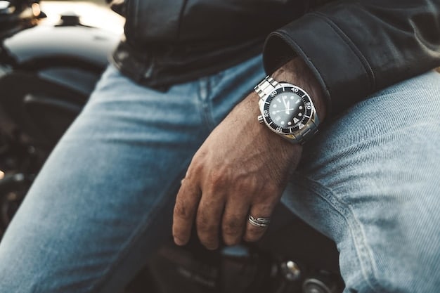 A close-up shot of a man's wrist showcasing a luxury watch with a stainless steel bracelet and a blue dial, highlighting the watch's intricate details and its contribution to The Power of Accessories: 6 Ways to Elevate Your Men's Style Instantly.