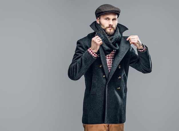 A man showcasing a layered outfit with attention to accessories. He's wearing a wool coat, a sweater, and a collared shirt, accessorized with a patterned scarf, leather gloves, and a knit beanie. The setting is a stylish urban environment, emphasizing the fashion-forward aspect of layering. Focus on accessories that complement The Art of Layering: Mastering Men's Style for Fall and Winter.