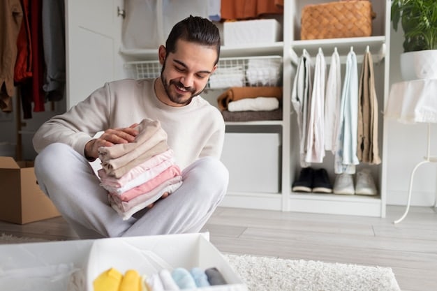 A man organizing his closet, neatly arranging clothes made from sustainable materials like organic cotton and recycled fabric. The closet is minimalist and well-organized, showcasing a commitment to Sustainable Style: Building an Eco-Friendly Men's Wardrobe in 2025 through mindful consumption and organization.