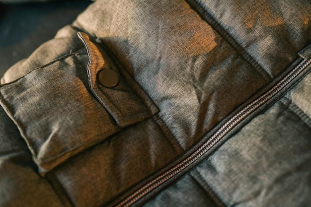 A close-up shot of different fabric swatches used for men's outerwear, including wool, cashmere, leather, and waxed cotton. Each swatch is labeled with the fabric name.