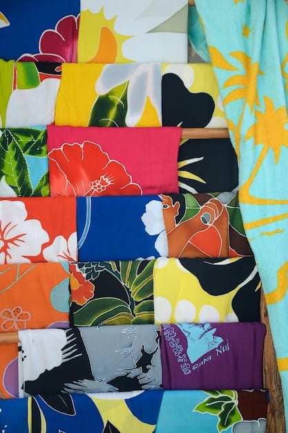 A close-up shot of various tie fabrics and patterns, showcasing bold floral designs, geometric shapes, and vibrant color palettes that are trending for The Return of the Tie: How to Wear a Tie in 2025.