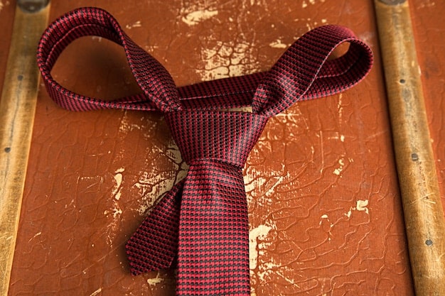 A display of different tie knots, including the Four-in-Hand, Half Windsor, and Full Windsor, each paired with a different shirt collar, demonstrating how to match the knot to the collar style for The Return of the Tie: How to Wear a Tie in 2025.