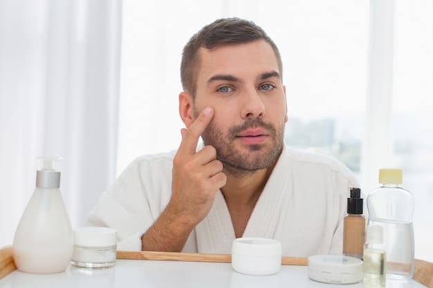 A man is applying a pea-sized amount of retinol cream to his fingertips, ready to apply it to his face. The background is a clean bathroom counter with various skincare products.