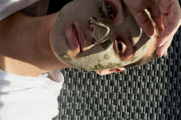 A person applying a clay mask to their face in a well-lit bathroom. The focus is on the mask's texture and coverage, highlighting its ability to absorb excess oil.