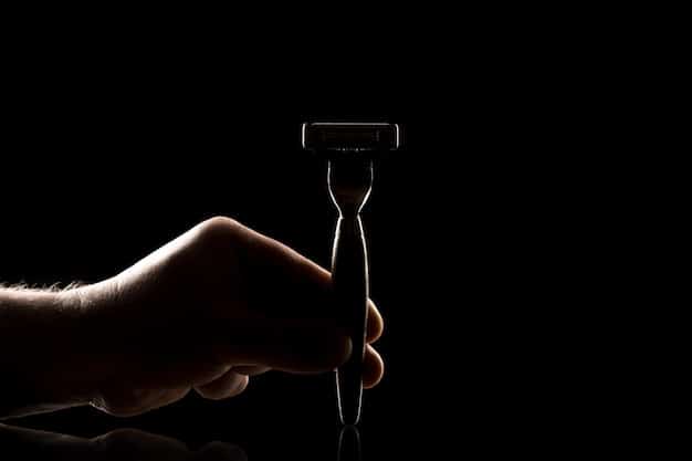 A man's hands holding a high-quality, sharp razor. The focus is on the sharpness and cleanliness of the blade, emphasizing its importance in preventing ingrown hairs. The man looks focused, ready to prepare his skin for Ingrown Hairs Be Gone: Expert Shaving Tips for Men.