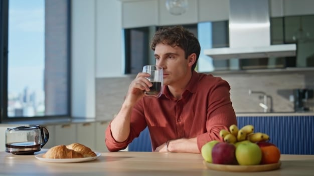 A man drinking water and eating a healthy snack, highlighting the importance of diet and hydration in Acne Treatment for Men: A Step-by-Step Guide to Clearer Skin. The setting is a clean, modern kitchen.
