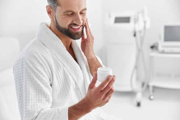 A man gently applying moisturizer to his cleansed face in the bathroom, emphasizing the importance of a calming and hydrating skincare routine for men experiencing redness and irritation.