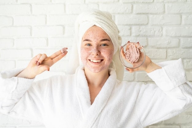 A person applying a gentle facial scrub to their face with soft, circular motions, illustrating proper and safe physical exfoliation technique.