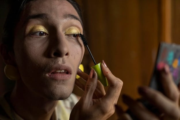 Manny MUA is pictured applying eyeshadow to his eye with precise technique. The image highlights his expertise in makeup artistry, with a focus on color blending and product application. The image captures the artistry aspect of the growth of male beauty influencers.