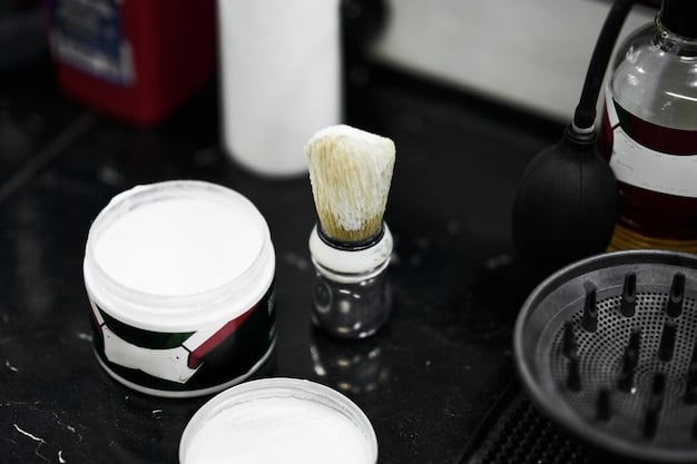 A close-up shot of various men's hair styling products (pomade, wax, gel, clay) arranged on a dark wooden surface. The products are neatly organized and the lighting highlights their textures and labels. The focus is on showcasing the variety of textures and packaging available in 2025's Best New Hair Styling Products for Men: Ranked by Hold, Shine, and Price.