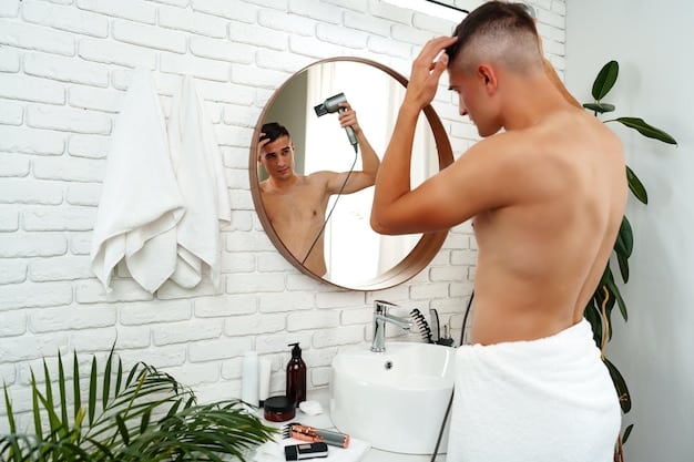 A man applying hair clay to his hair while looking in the mirror. He is dressed casually and the bathroom setting is clean and modern. The image illustrates the application process of using clay-based styling products, highlighting its ease and effectiveness in achieving a textured hairstyle, relevant to understanding 2025's Best New Hair Styling Products for Men: Ranked by Hold, Shine, and Price.