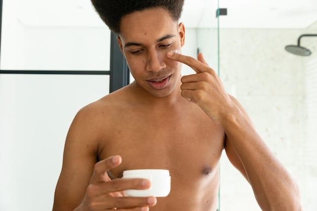 A man applying exfoliating scrub to his face in a bathroom setting. The focus is on the texture of the scrub and the gentle massaging motion. The image suggests a step in a skincare routine relevant to 'New Year, New Face: Reviewing the Top 3 Exfoliating Scrubs for Men in January 2025'.