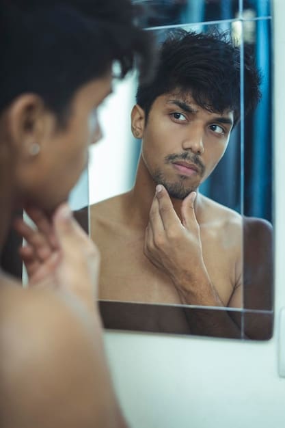 A man examining his skin in a mirror, trying to determine his skin type. The image conveys the importance of understanding one's skin before choosing skincare products, as highlighted in The Ultimate Guide to Men's Makeup Removers in 2025: Which One Removes All Traces in Under 60 Seconds?.