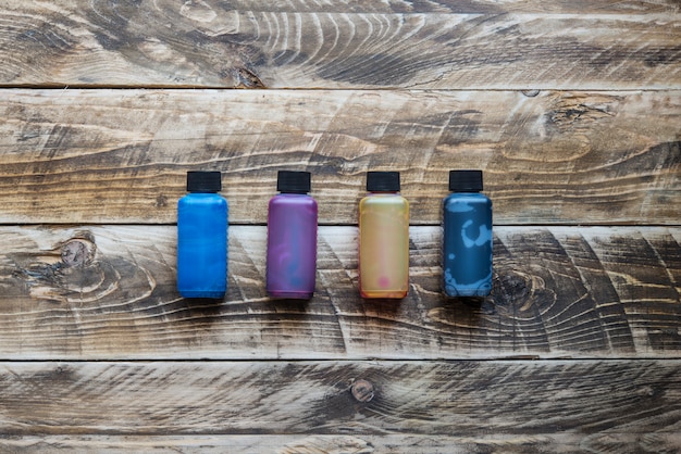 A photo showing four different bottles of men's toners, each labeled with a number 1-4. The background is a clean, well-lit bathroom setting, and a measuring tape is subtly placed next to the bottles to represent the accurate measurement of redness reduction during We Tested 4 New Men's Toners: Find Out Which One Reduced Redness by 25% in 7 Days.