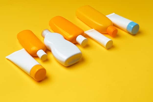 A close-up shot of various sunscreen bottles and tubes arranged on a clean white surface. The focus is on the labels, highlighting key ingredients like 