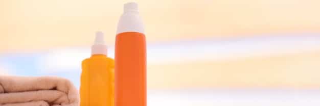 A split image comparing a lower-priced, basic sunscreen bottle next to a higher-priced, premium sunscreen bottle. The background is blurred to keep the focus on the two products.